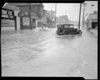 Storm-flooded street in a commercial area, [Los Angeles County?], 1933