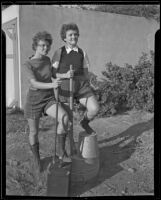 Nell Herring and Mary Nan Gooch, who climbed Mount Whitney, pose holding walking sticks, Los Angeles, 1935