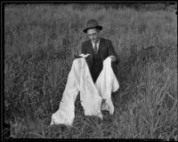 Unidentified detective with William Hardy's blood-stained clothing, Los Angeles, 1935