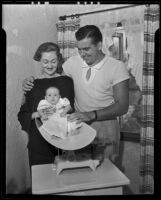 Former University of Southern California football star Alvie Coughlin and wife, Betty, weigh daughter, Sharon, Los Angeles, 1935