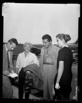 Actress Lana Turner with a news reporter, Johnny Stompanato and daughter Cheryl in Los Angeles, Calif., 1958