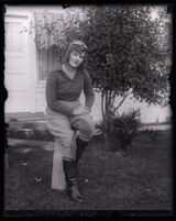 Aviatrix Peggy Paxson sitting in her aviator's outfit, Los Angeles, circa 1929