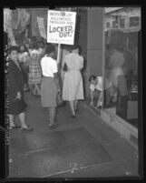 Lady garment workers picketing as store manager Dave Schultz draws "don't cross" line on sidewalk in Los Angeles, Calif., 1947