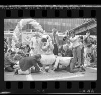 Disney's Donald Duck setting his footprints in cement of courtyard at Chinese Theatre in Los Angeles, Calif., 1984