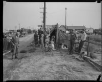 Homeless family outside their tent in a Hooverville, Los Angeles, circa 1940