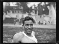 Don Plumb, Pomona College sprinter, relaxes on Patterson Field during a track meet, Los Angeles, 1932