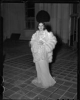 Model Jeannette Warren in chiffon gown and fur wrap, Times Fashion Show, Los Angeles, 1936