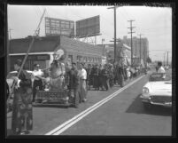 Procession for warrior Kwong Kong statue traveling down Broadway Street in Los Angeles, Calif., 1960