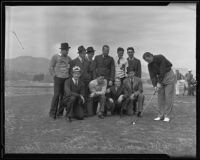 Johnny Weissmuller demonstrates his golf swing in front of a group of unidentified S.M.U. football players, Pasadena, 1935