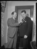 Beverly Hills police chief Charles C. Blair pinning medal on Captain Matt Vallance, [Beverly Hills?], [1937?]