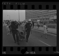 Protester dragged by police on Avenue of the Stars outside of Century Plaza Hotel, where President Johnson is speaking. A. 1967