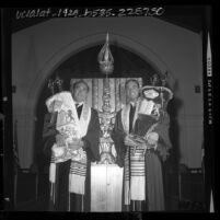 Rabbi Isaiah Zeldin with student Rabbi Harvey Block holding Torah scrolls in front of new Ark at Stephen S. Wise Temple, Los Angeles, Calif., 1964