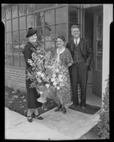 Mrs. Oscar Rosbach, Mrs. F. W. Collins, and Mr. F. W. Collins pose with flowers at the opening of the San Marino Tribune newspaper plant, San Marino, 1936