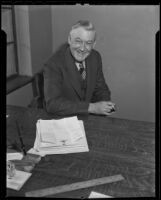 Spider Baum seated at a desk, Los Angeles, 1935