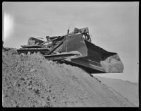 Unidentified worker sitting in a bulldozer, Calexico, 1936