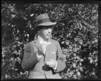 Crown Prince Gustav Adolf of Sweden tries an orange at an orchard, Riverside, 1926