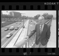 Caltrans' Chuck O'Connell on pedestrian bridge above the Harbor Freeway, Calif., 1986