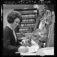 Paula Harford, audio visual clerk working at splicing unit in film unit of Pomona Public Library, Calif., 1966