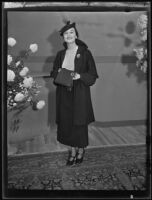 Woman models muff-purse (?) combo at the Times' fashion show, Los Angeles, 1935