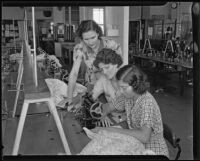 Three women using a sewing machine at the Frank Wiggins Trade School, Los Angeles, 1935