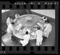 UCLA medical students observing an operation from above through dome, 1965