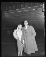 Marilyn Monroe accompanied by her husband, playwright Arthur Miller arrives at Los Angeles International Airport, 1959