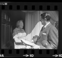 Governor Ronald Reagan on special election petition drive, talking with Virginia Ferguson at her home in Pacific Palisades, Calif., 1973