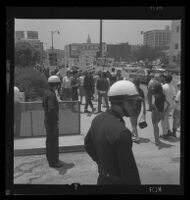 Protesting in front of police headquarters in response to police conduct at Century Plaza demonstration during President Johnson's visit, 1967