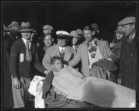 George Young rests after swimming 22 miles across the Catalina Channel at Point Vicente, Los Angeles, 1927