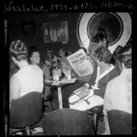 People at Christian nightclub Right On, one reading Hollywood Free Paper, in Los Angeles, Calif., 1971