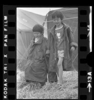 Two Vietnamese boys wearing marine jackets at refugee camp at Camp Pendleton, Calif., 1975