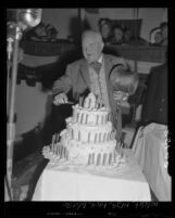 Mayor Fletcher Bowron cutting a birthday cake marking the Centennial anniversary for the city of Los Angeles, Calif., 1950