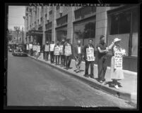 Men and women of the Los Angeles Public Works and Unemployed Union picketing outside W.P.A. headquarters, 1936