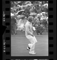 Golfer Jack Nicklaus tossing his putter into air at Bob Hope Desert Classic in Palm Springs, Calif., 1973