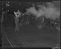 Detective Lieutenant George Hill shoots tear gas toward Los Angeles Railway strikers, Los Angeles, 1934