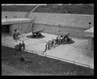 Members of the first civilian coast artillery crew load a mortar battery gun at Fort MacArthur, San Pedro, 1921