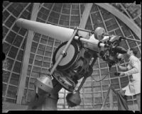 Maxwell K. Baughman looking through the Zeiss refracting telescope at the Griffith Observatory, Los Angeles, 1934-1935