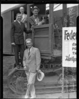 J.B. Irsfeld, Will Hays, Henry B.R. Briggs, and steam shovel operator in steam shovel for Hollywood post office ground breaking, with color guard, Hollywood, 1935