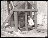 Two men standing at the construction site for the San Gabriel Dam, Los Angeles County, 1920s