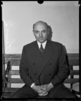 S.C. Lewis sitting on bench, Los Angeles, [between 1927-1937]