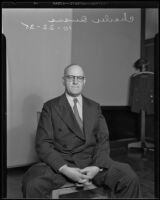 Los Angeles Times illustrator Charles Owens sits gazing into camera, Los Angeles, 1935