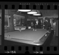 Actor Ryan O'Neal playing pool with three ladies at the Playboy Mansion in Los Angeles, Calif., 1971