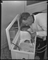 Fireman, Edwin Reed, with rescued baby, Patty Lou Williams, Los Angeles, 1935