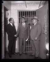 Jailer Clem Peoples, prisoner Asa Keyes and Sheriff Frank Cochran at the county jail, Los Angeles, 1930