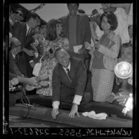 Frank Sinatra leaving his signature in cement at Grauman's Chinese Theatre in Hollywood (Los Angeles), 1965