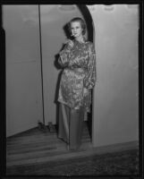 Actress Louise Brien lighting a cigarette at Times' fashion show, Los Angeles, 1935