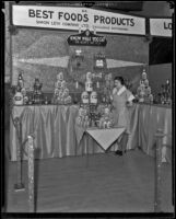 Billie Johnson stands in front of the Best Foods exhibit at the Food and Household Show, Los Angeles, 1933