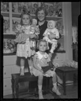 Harriet McCabe and 3-year-old girls Sally Anne Davis and Nancy Lee Davis with Mrs. McCabe's doll collection, Pasadena, 1935