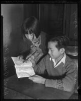 Hazel Quock and Warren Wong work on their Chinese lesson at the Chung Wah public school in Chinatown, Los Angeles, 1936