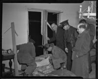 Officials inspecting Lyndon "Red" Foster's bombed window, Los Angeles, 1935